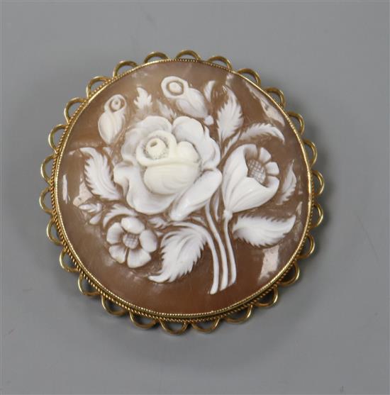 A 9ct gold-mounted circular cameo brooch carved with a spray of flowers, 38mm.